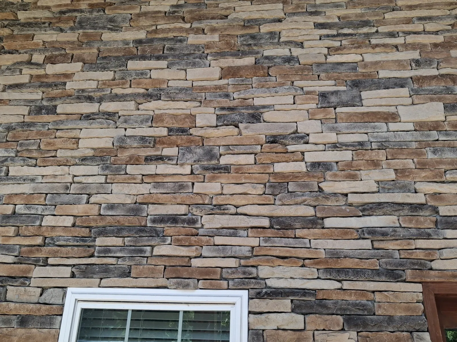 Ledge Stone veneer across an exterior wall in warm mixed tones