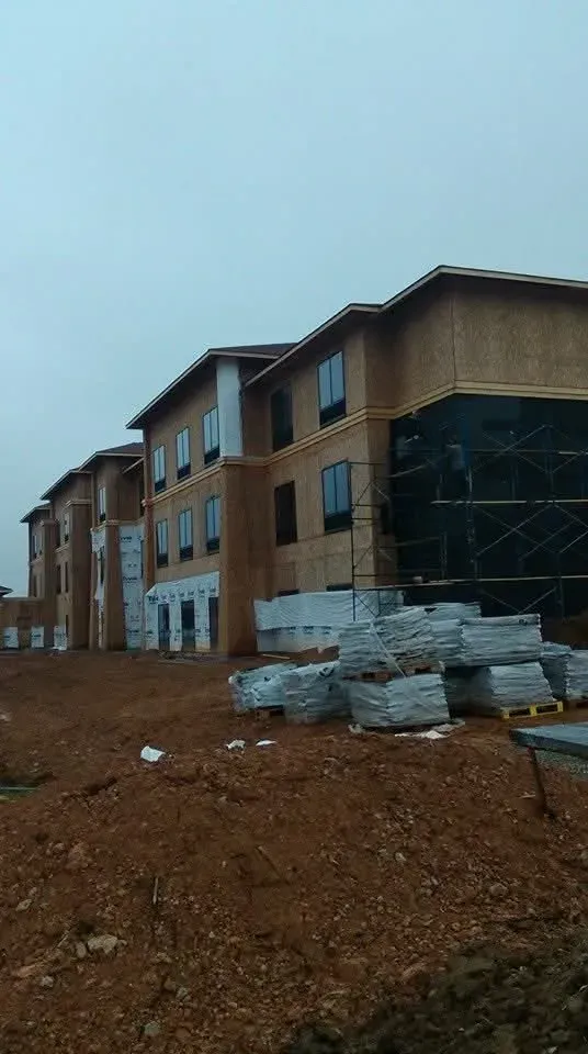 Hotel project in Indiana under construction, with scaffolding and pallets of stone on site