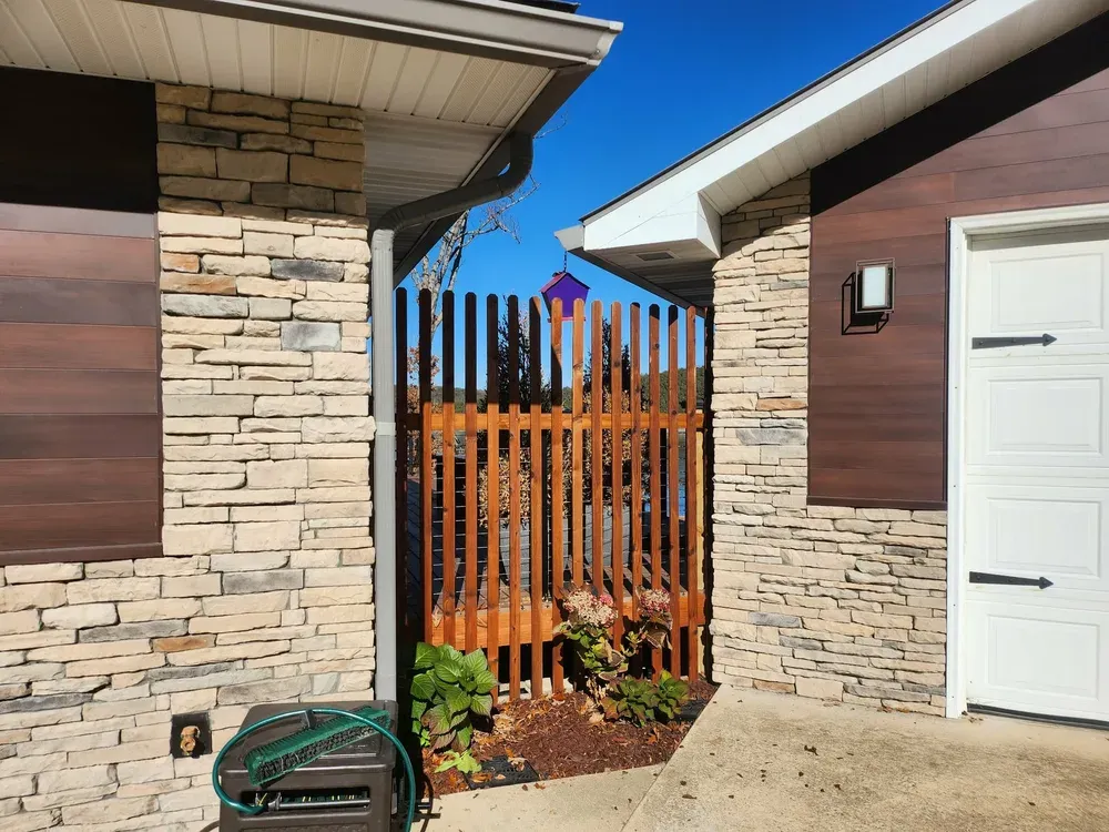 Stone entry columns framing a gate between buildings