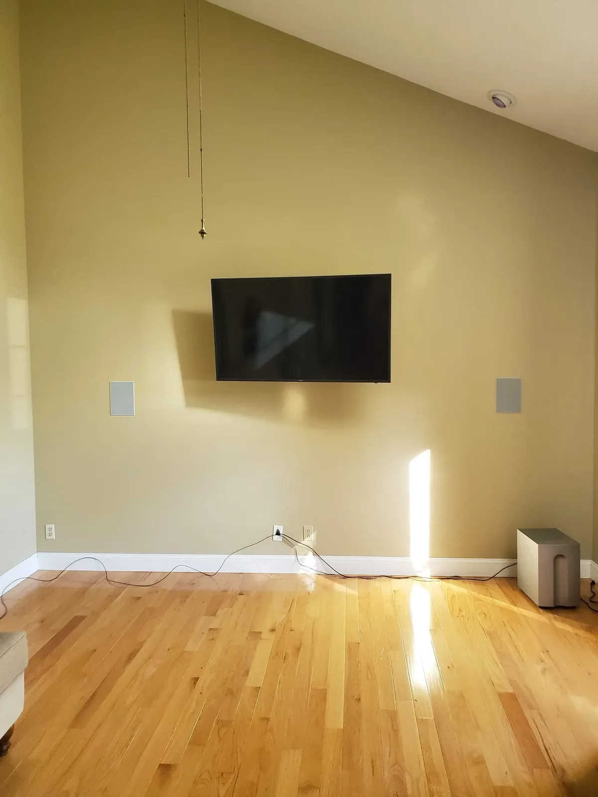 Living room wall before the limestone work, with only a television mounted