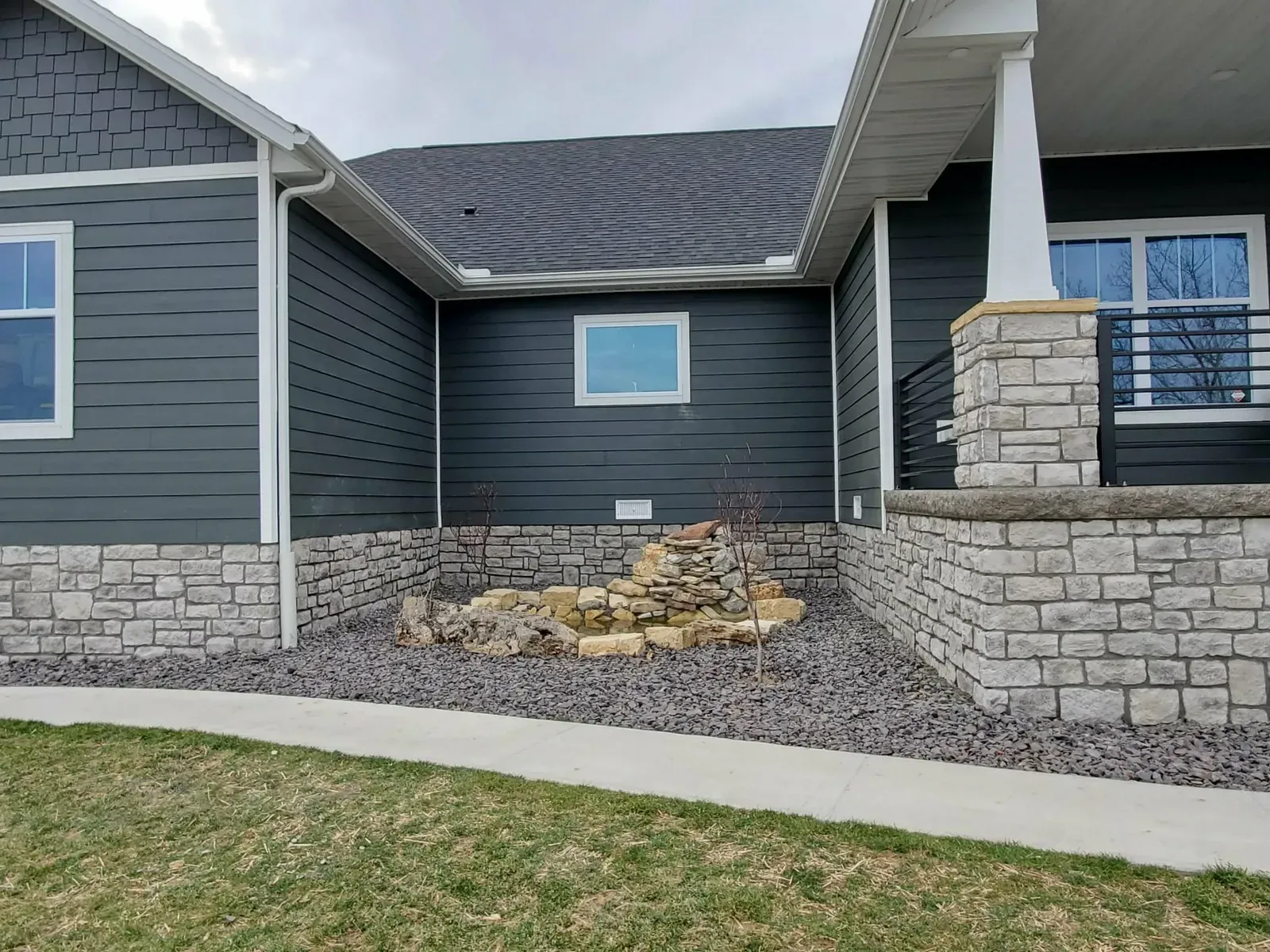 Home exterior with limestone foundation skirting and a limestone porch column base
