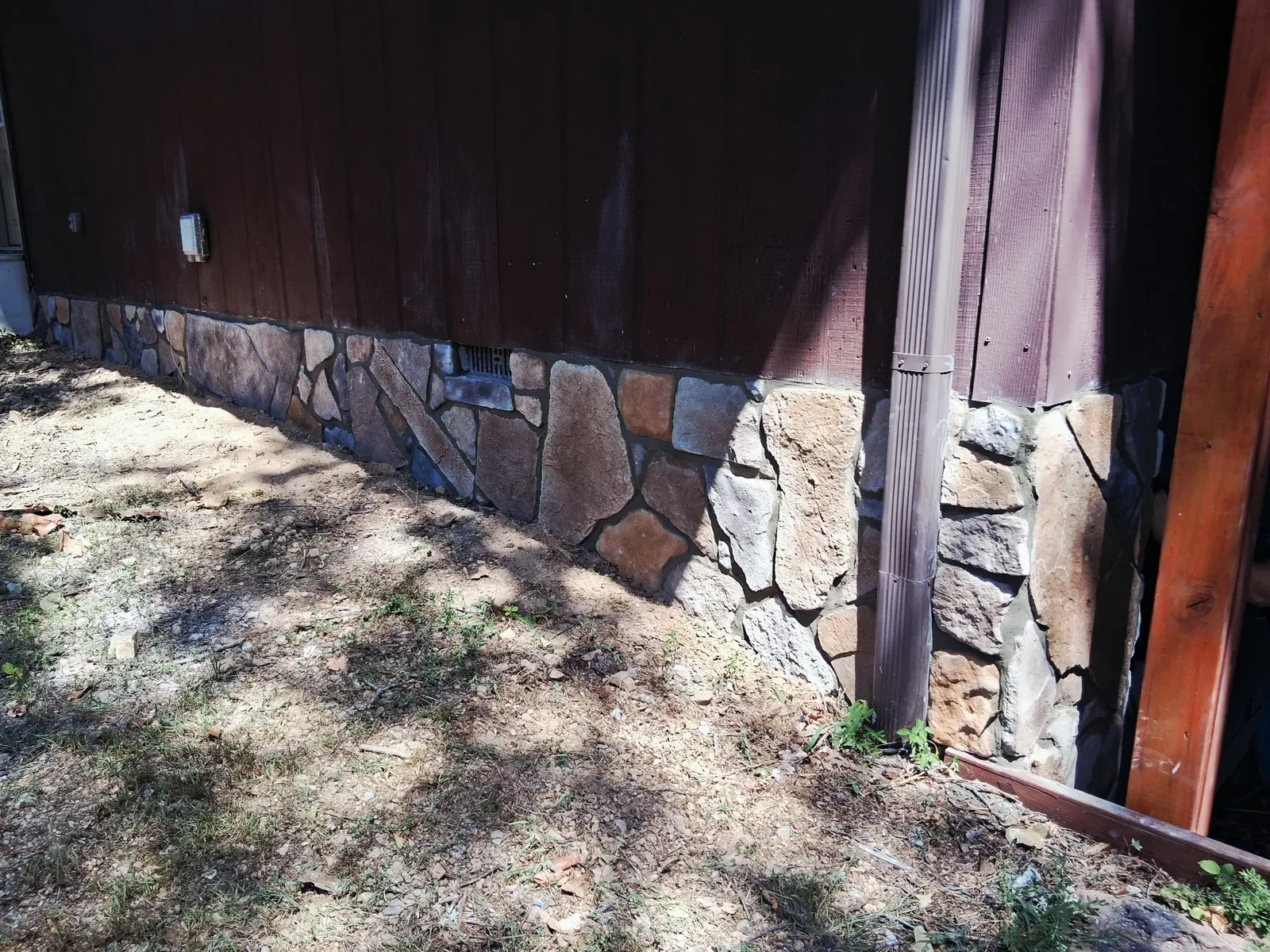Stone veneer installed along a prepared exterior wall base