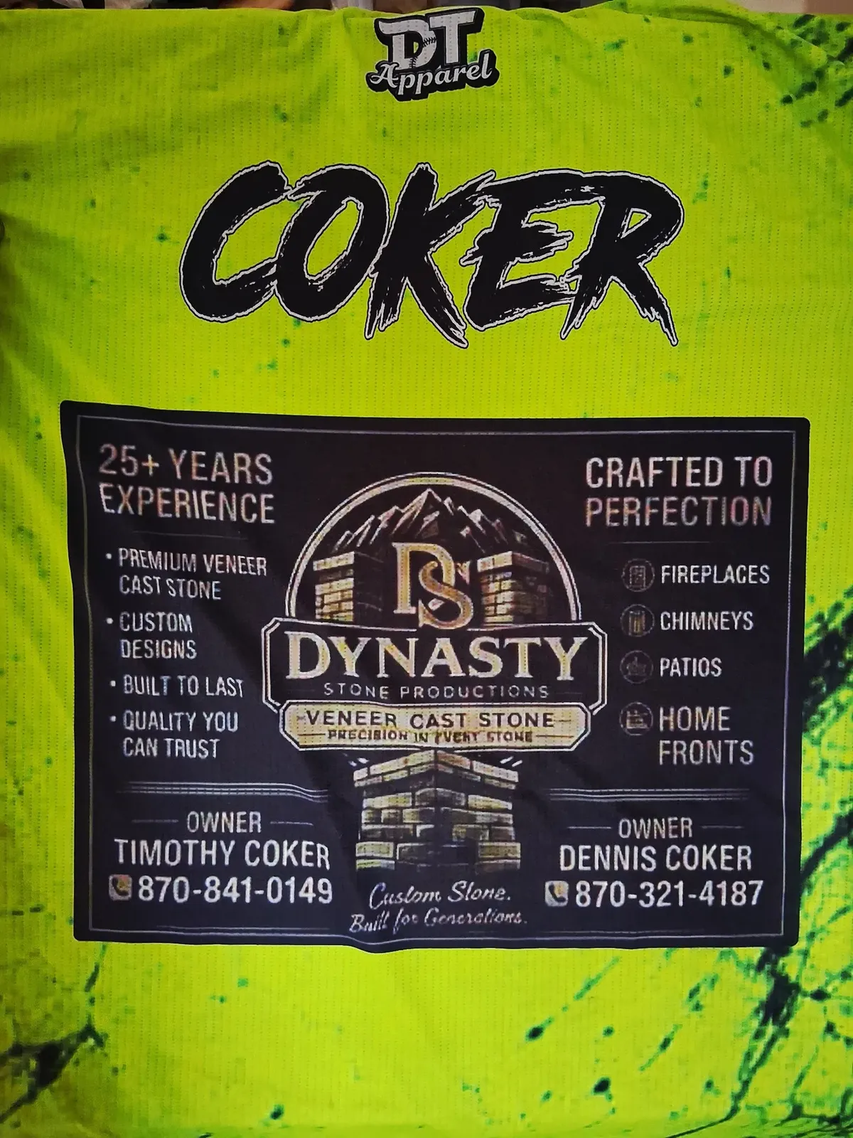 Back of the Rejects ball team jersey in neon green, with COKER across the shoulders and a Dynasty Stone Productions sponsor panel showing the company logo, owners Timothy Coker and Dennis Coker, and their phone numbers